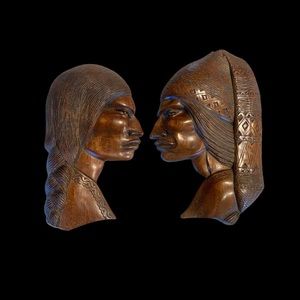 Carved wood Native American man & woman wall hangings.